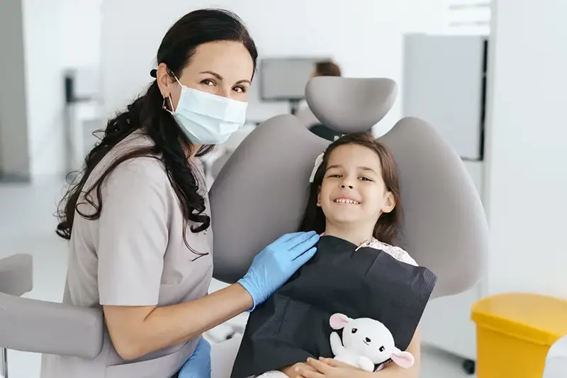 Happy child smiling with a dentist