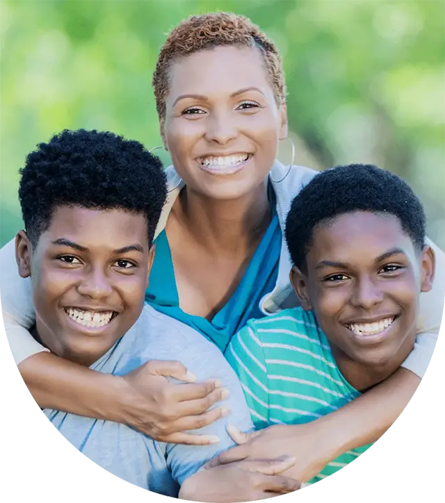 A mother hugging her two sons