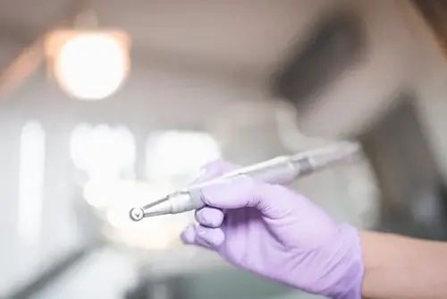 Dentist hand holding dental equipment