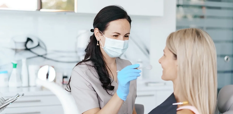 Dentist examines happy patient